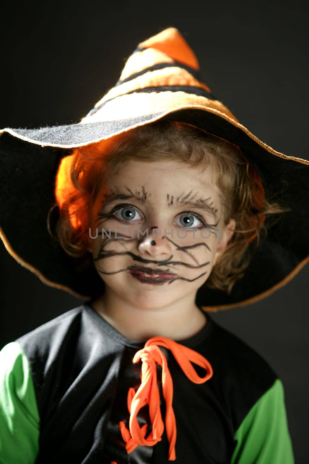 Toddler beautiful witch girl wearing halloween costume and make up