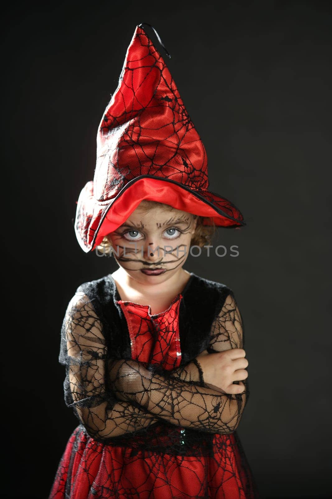 Toddler beautiful witch girl wearing halloween costume and make up