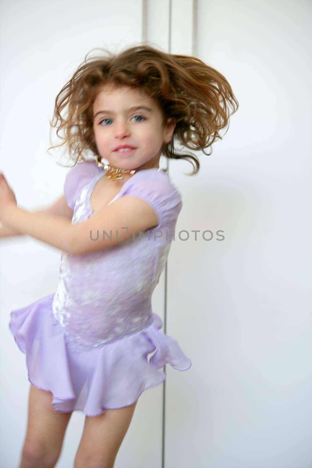 Beautiful girl dancing with motion blur, over white background