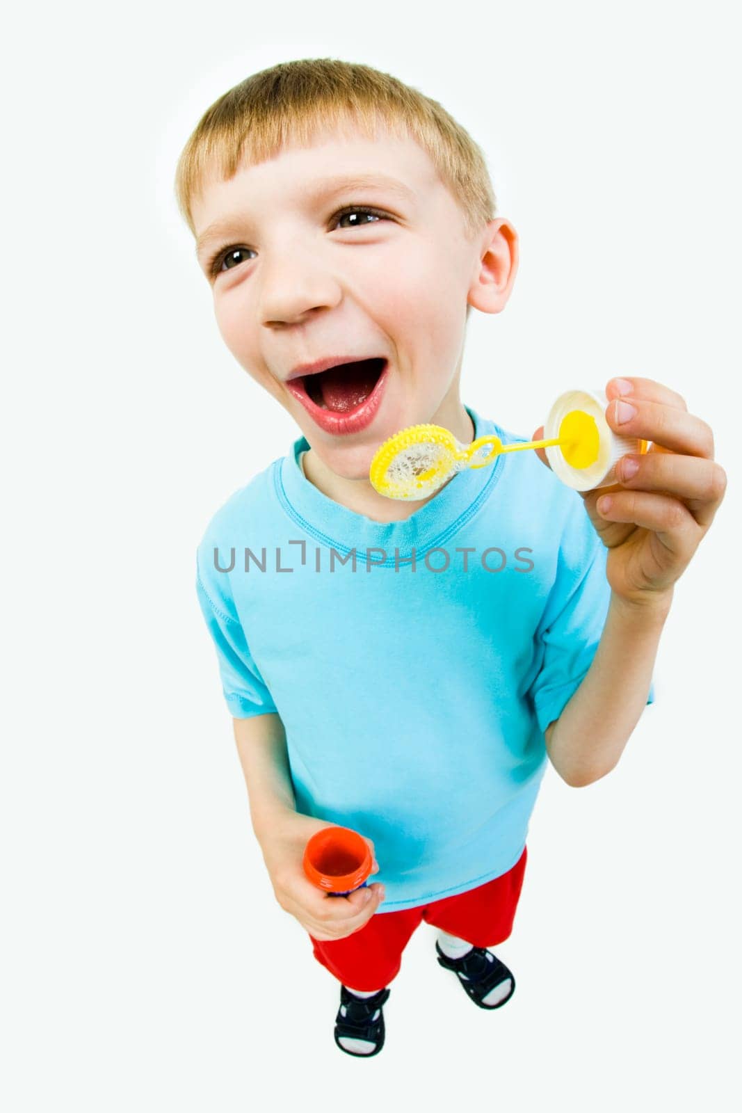 Portrait of cute boy preparing for blowing of soapy bubbles