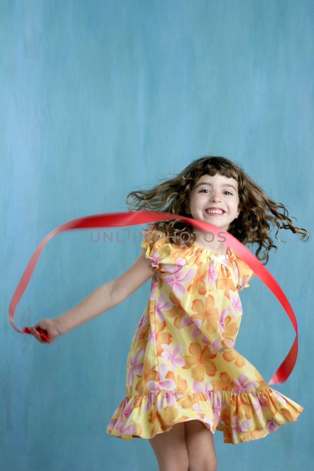 action little girl red ribbon tape dancing over green motion