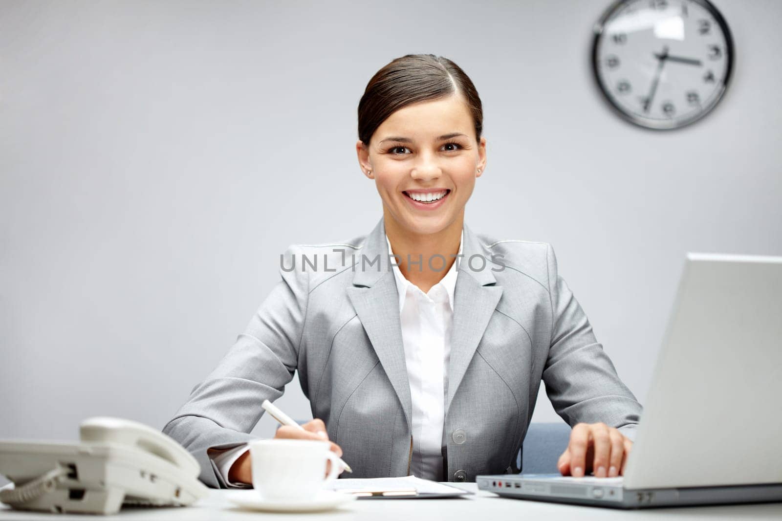 Image of young employer looking at camera while planning work in office