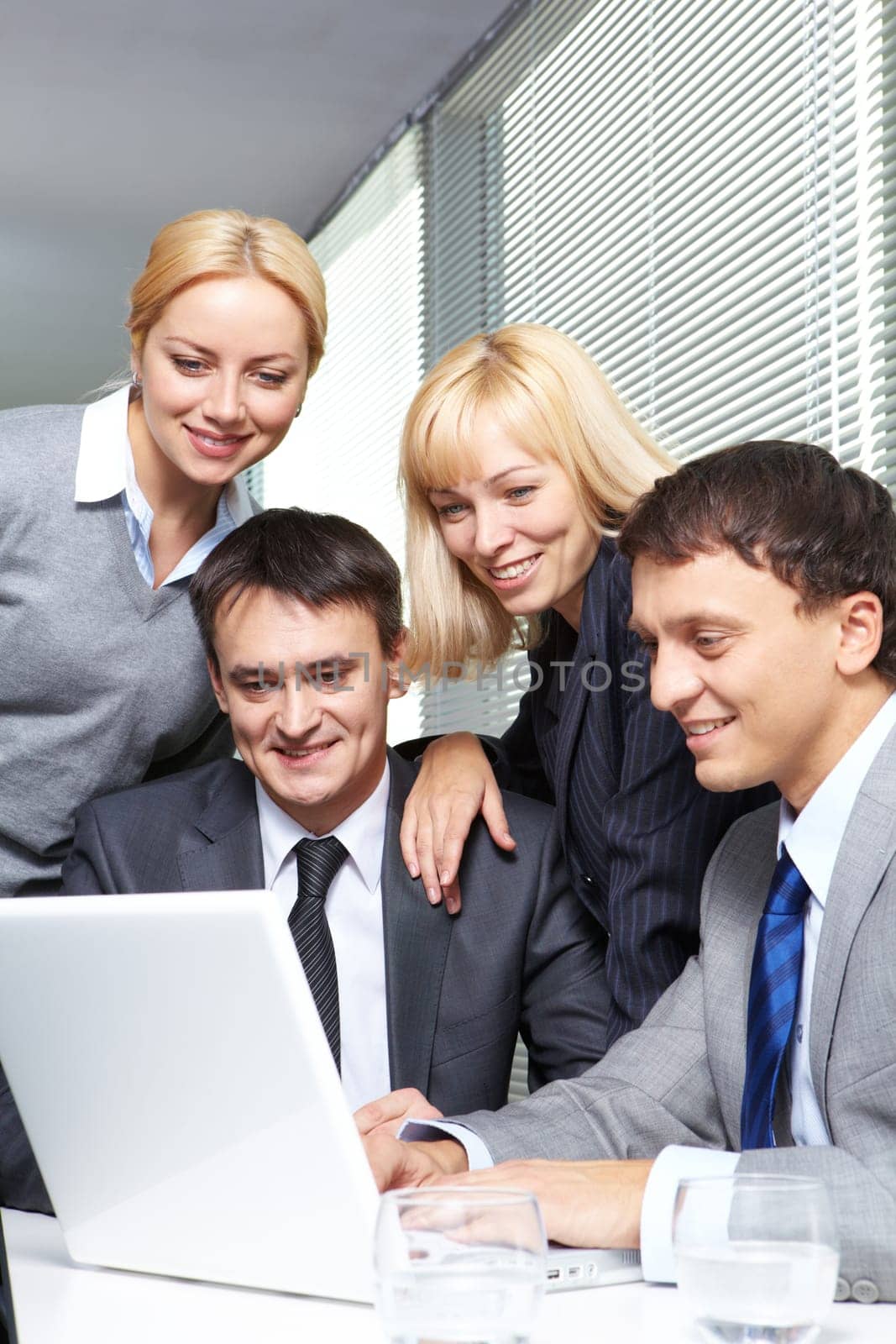 Four business people working in office