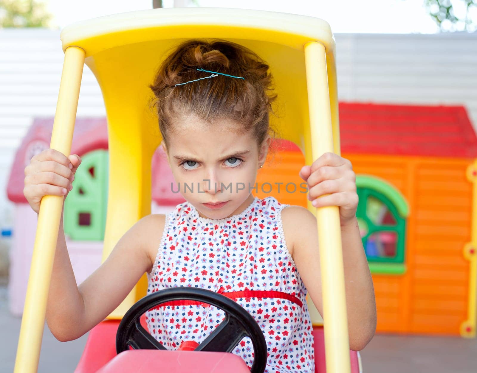 Angry toy car driver children girl in playground
