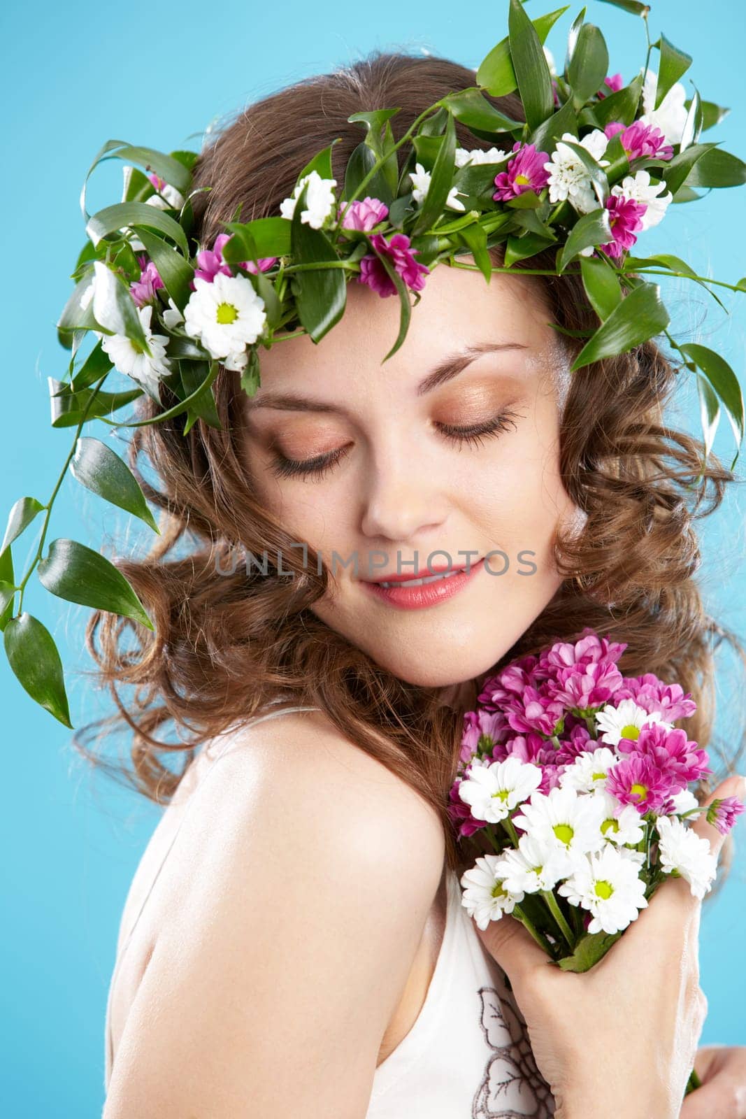 Beautiful woman in floral wreath looking aside
