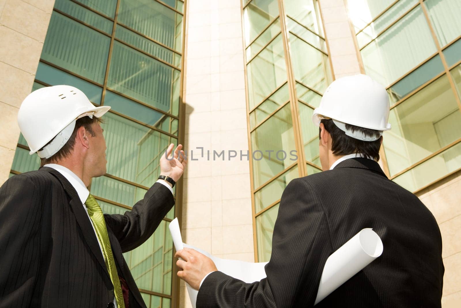 Portrait of customer showing building to architect