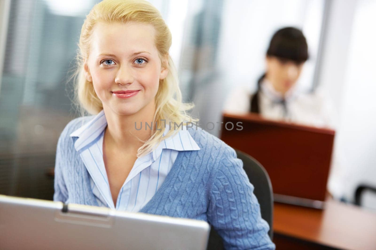 Portrait of a young beautiful businesswoman with a laptop