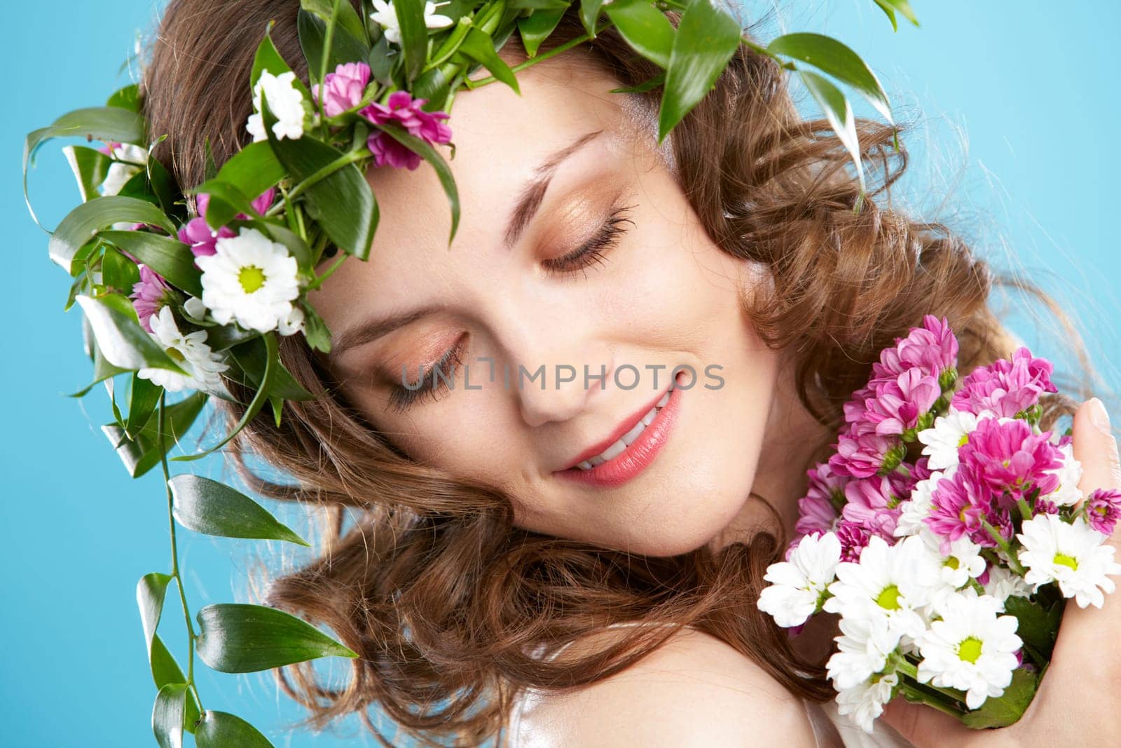 Beautiful woman in floral wreath looking aside