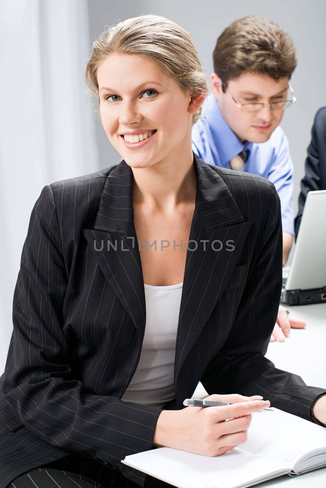Portrait of smart woman sitting at the table in a business environment