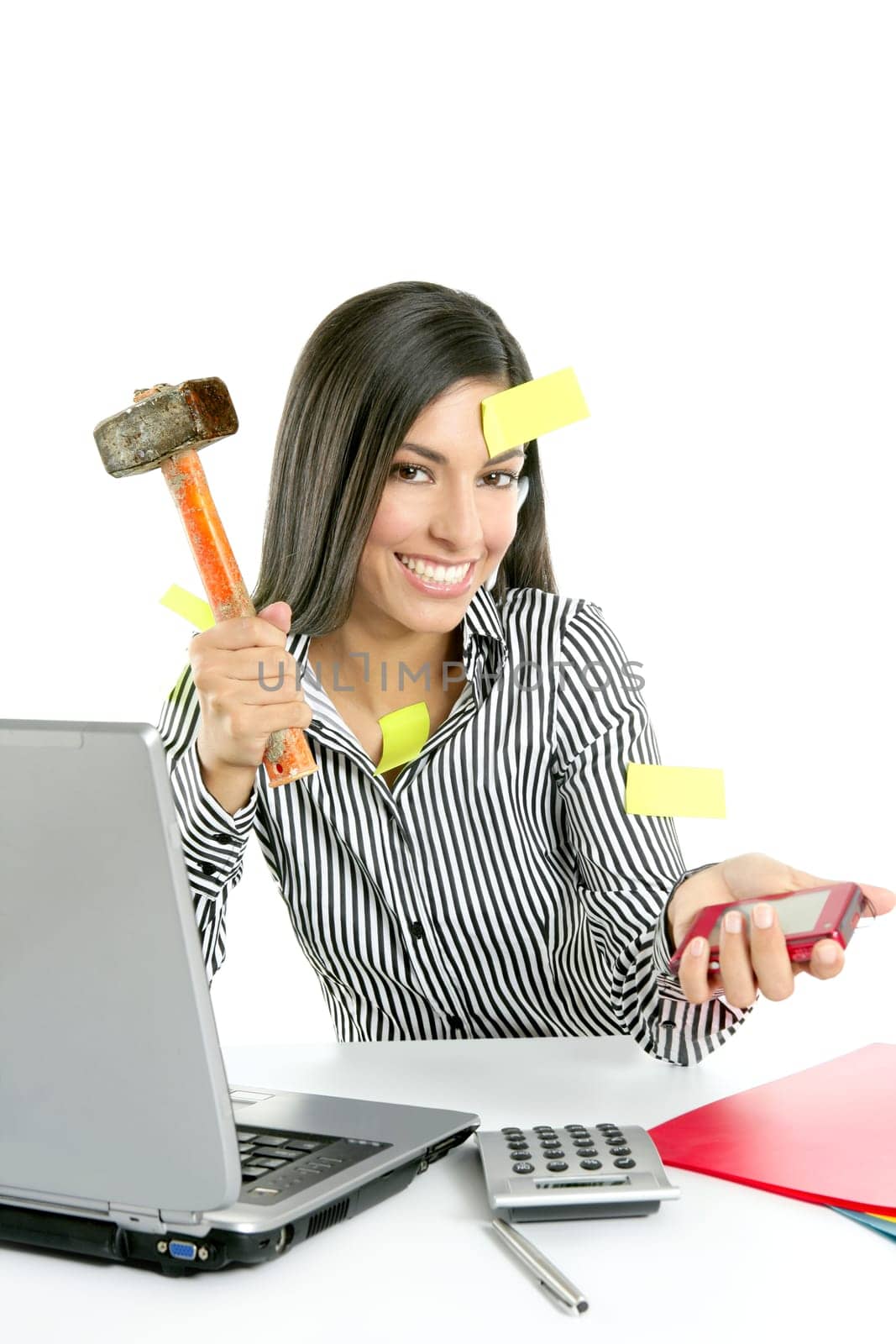 Angry brunette businesswoman with hammer against screen