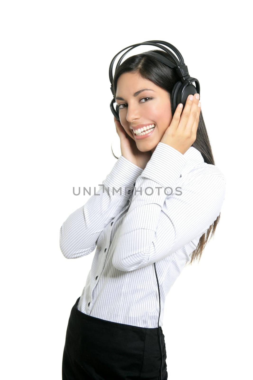 Beautiful brunette businesswoman hearing music on headphones