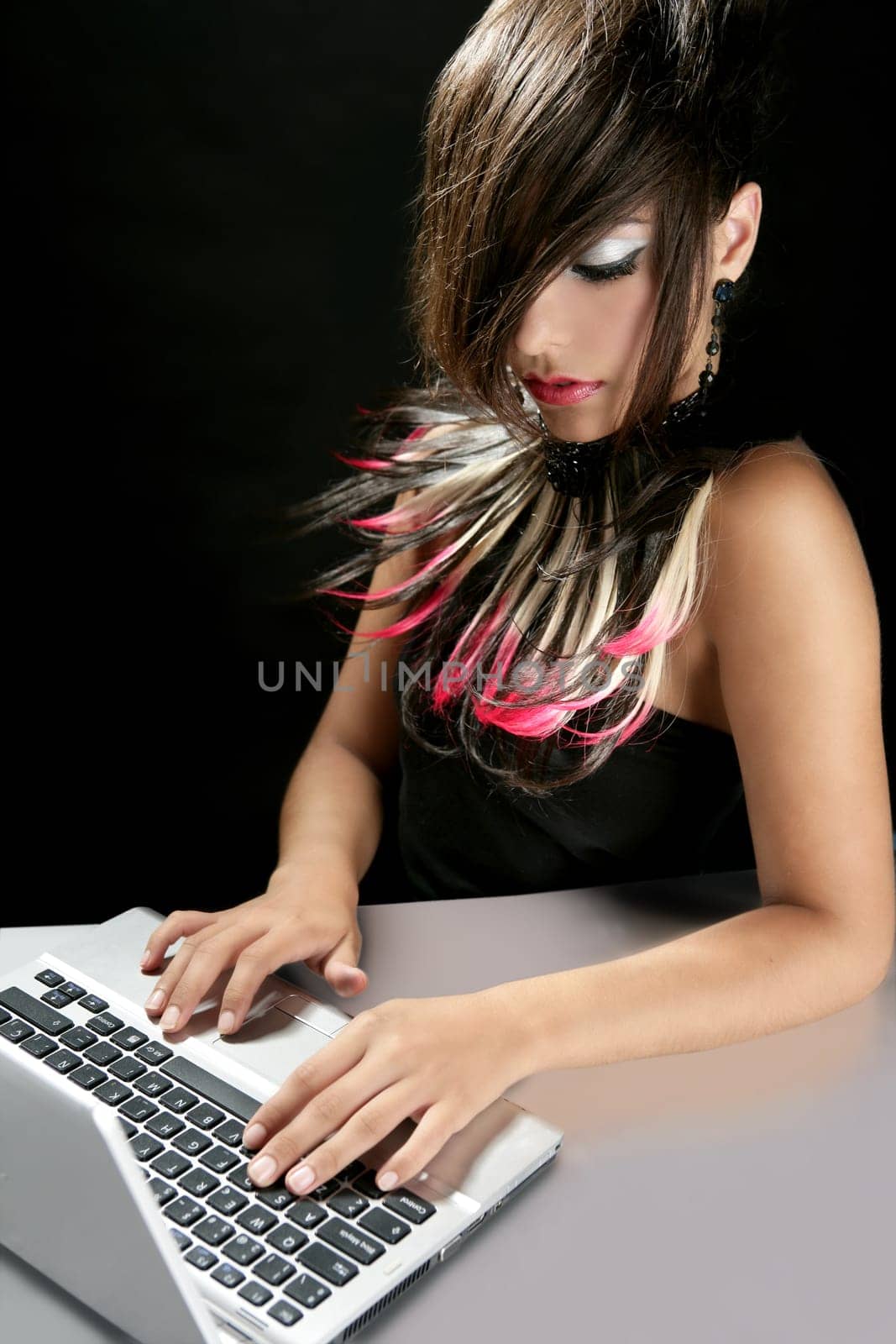 Attractive brunette fashion woman with laptop over black