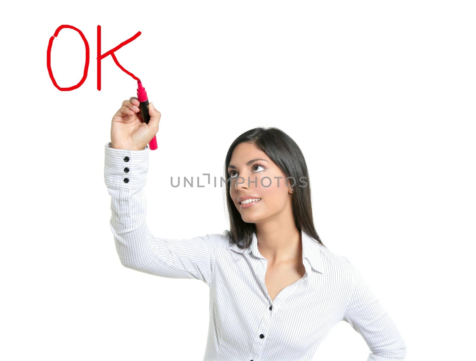 Brunette businesswoman writing word OK on a copyspace