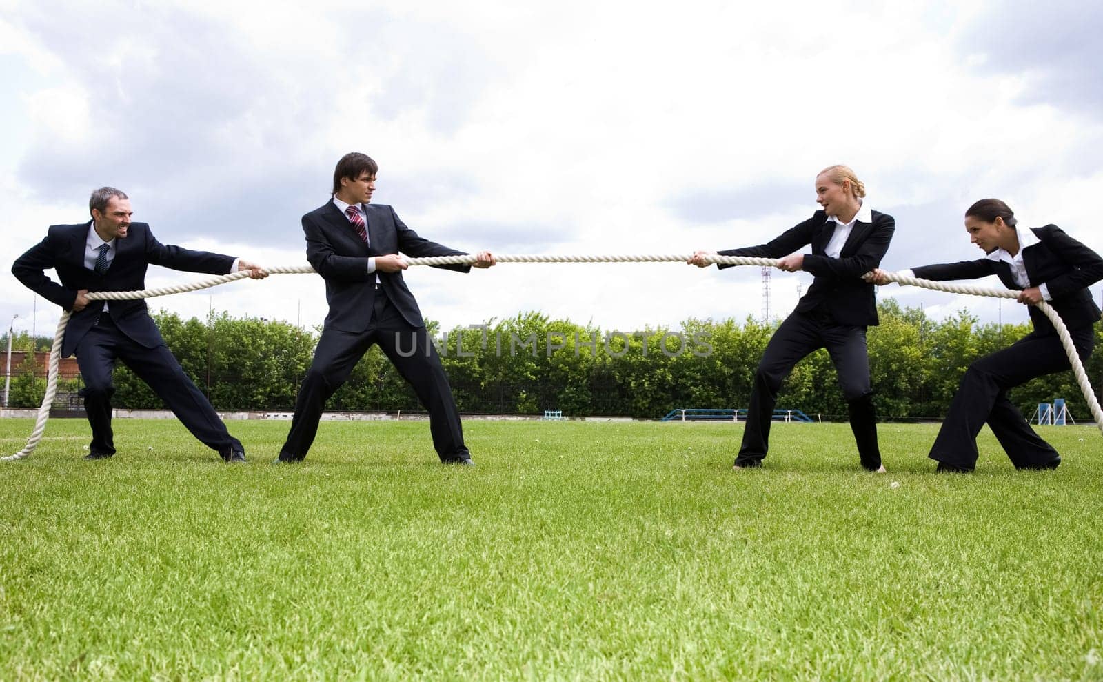 Photo of business people stretching the rope in the stadium