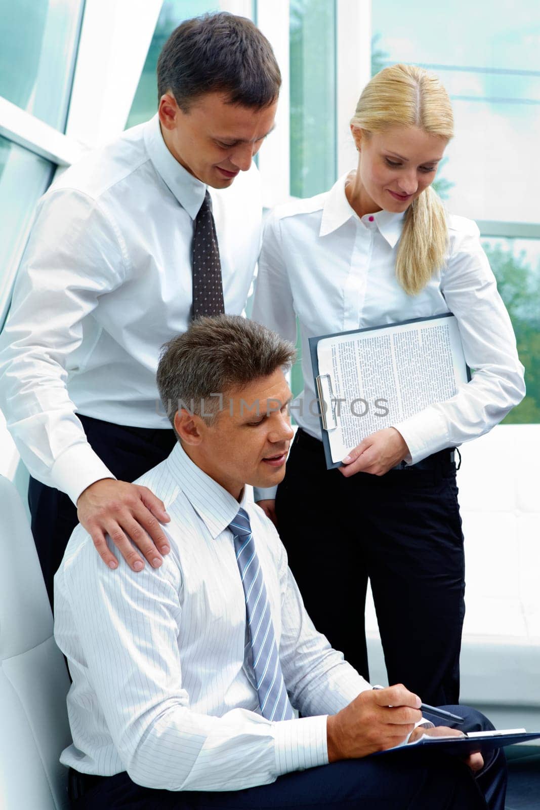 Photo of successful employees discussing business plan at meeting