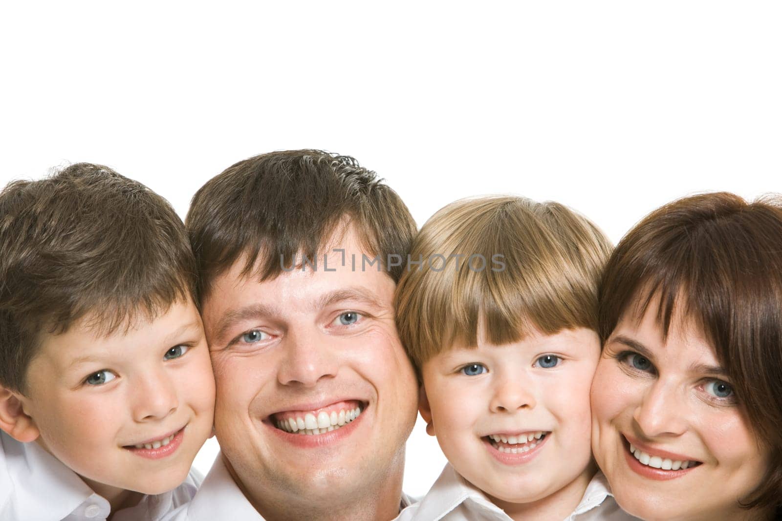 Faces of four family members looking at camera with happy smiles on white background