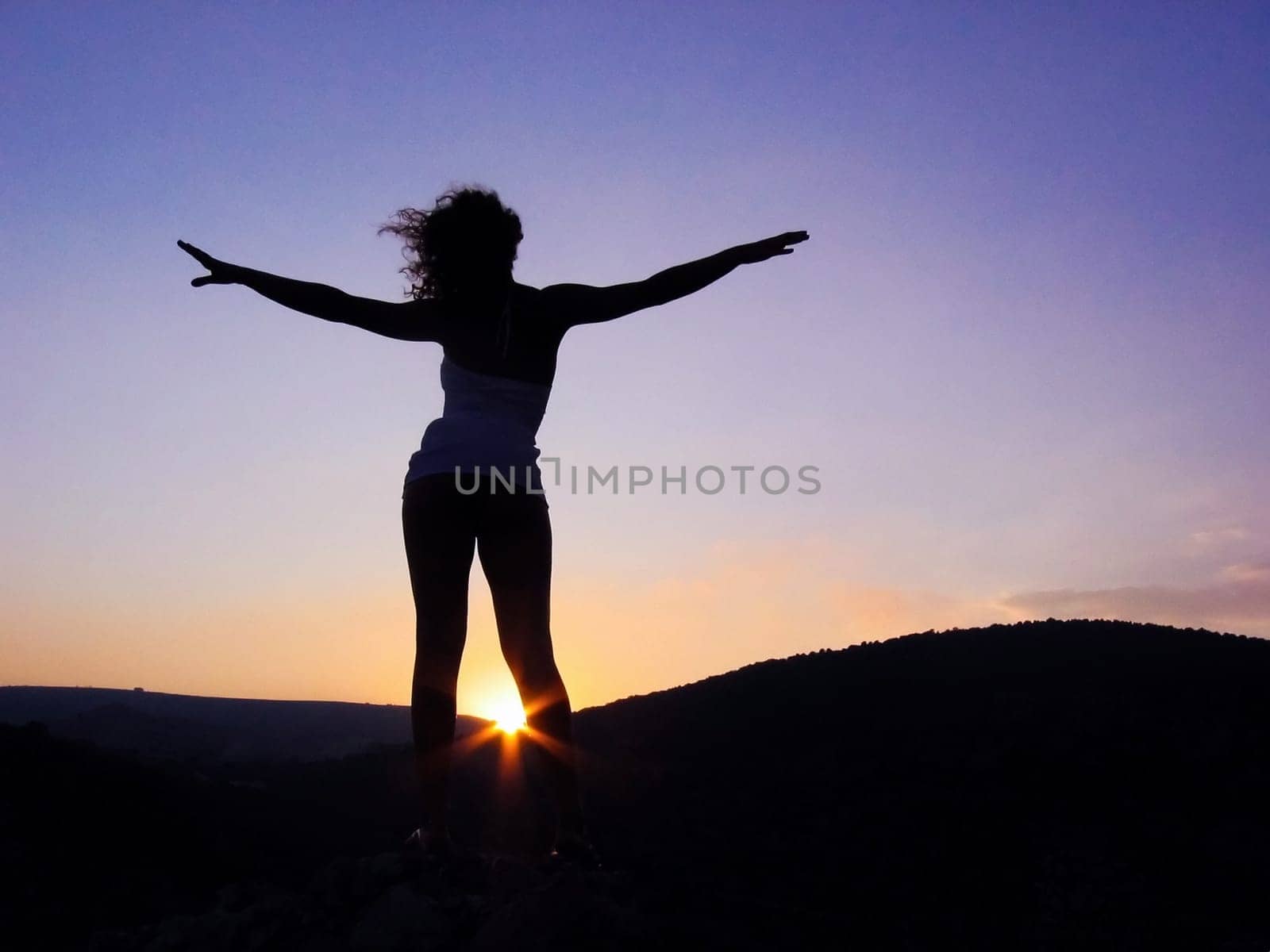 Photo of energetic female outline with stretched arms somewhere outside