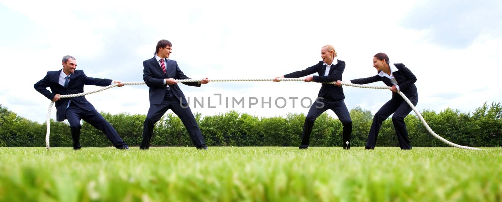 Photo of business people stretching the rope in the stadium