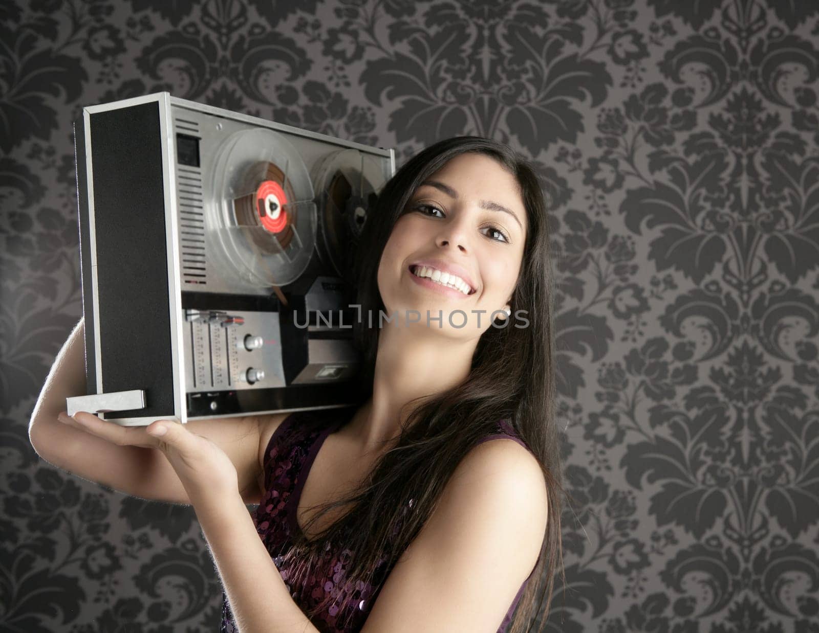 Retro open reel tape recorder beautiful brunette Dj hearing music gray walpaper