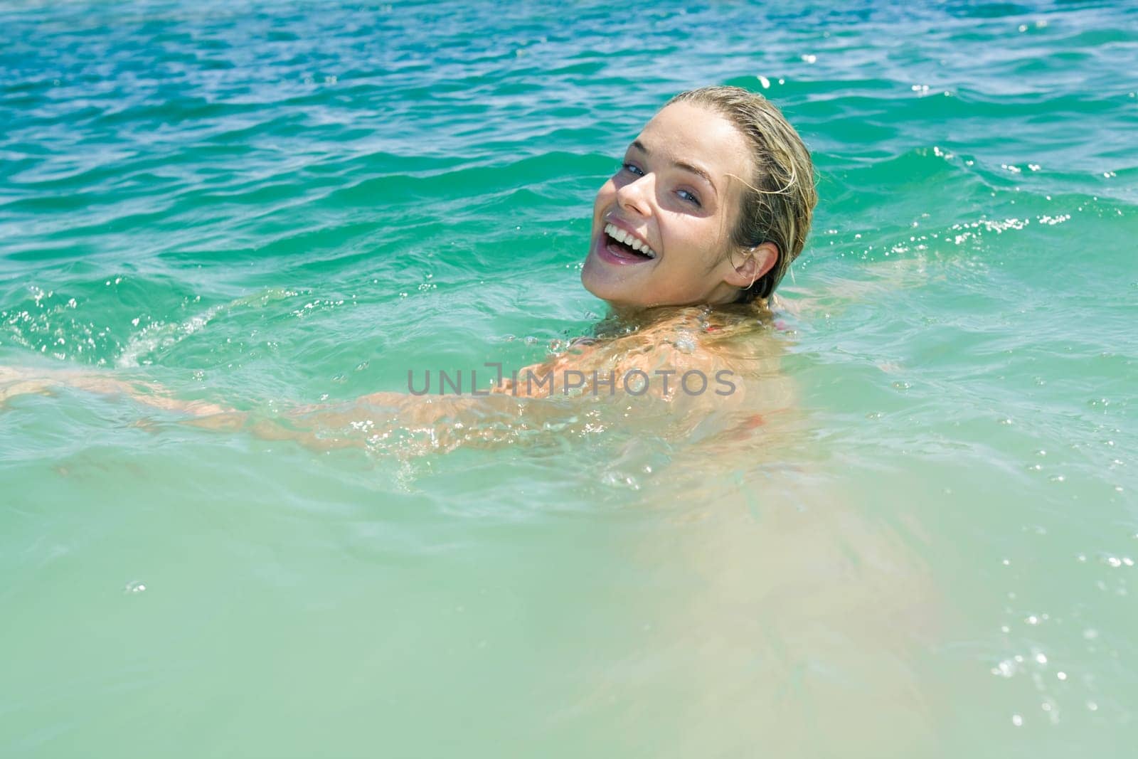Photo of pretty young woman swimming in the lake