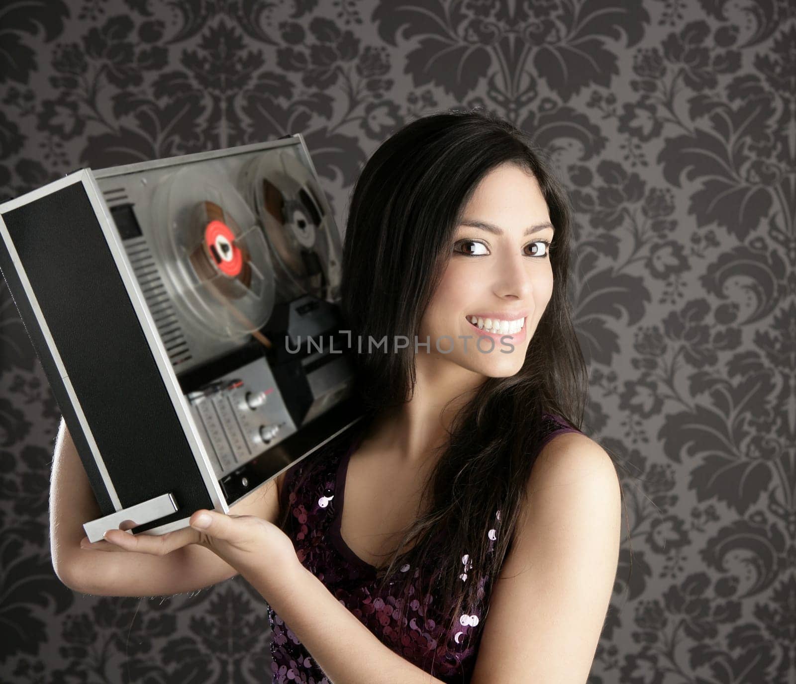 Retro open reel tape recorder beautiful brunette Dj hearing music gray walpaper