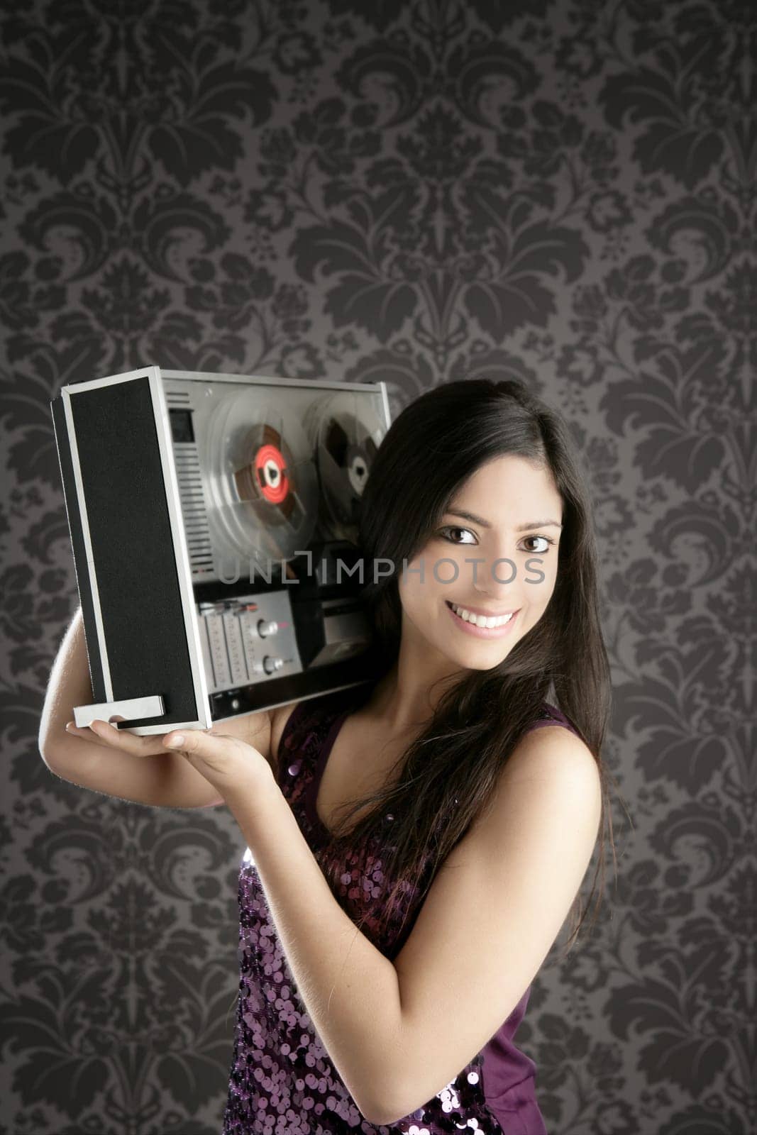 Retro open reel tape recorder beautiful brunette Dj hearing music gray walpaper
