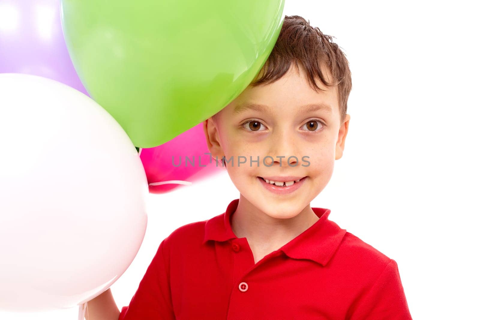 Portrait of happy boy with colorful balloons at birthday party