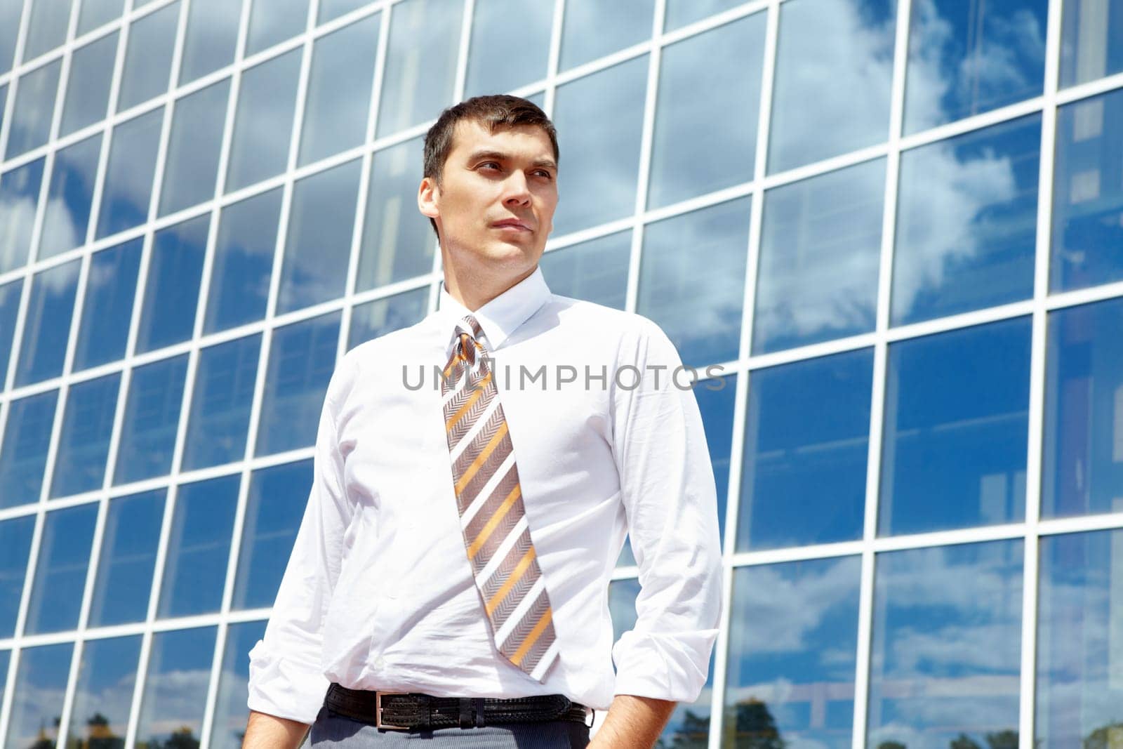 Portrait of confident businessman on background of office building