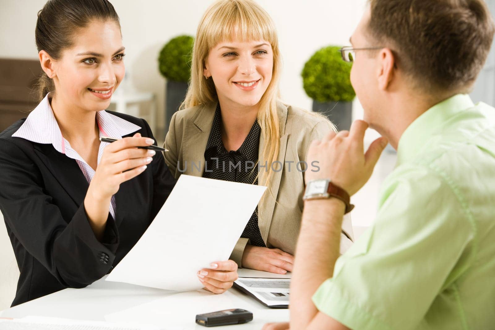 Portrait of business team communicating at meeting in the office