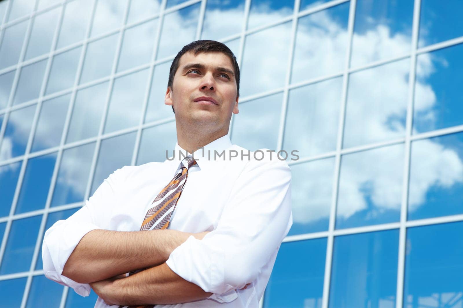 Portrait of confident businessman on background of office building