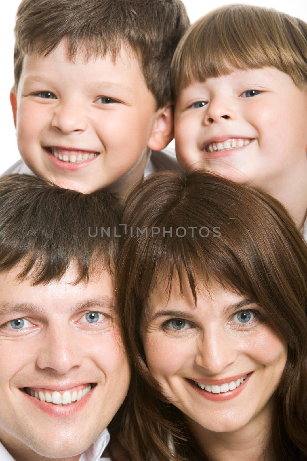 Photo of attractive father and mother with two siblings above them looking at camera