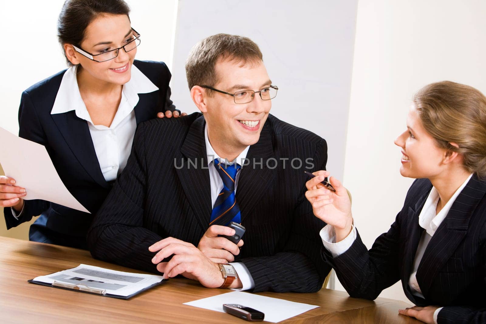 Image of business people looking at woman during discussion