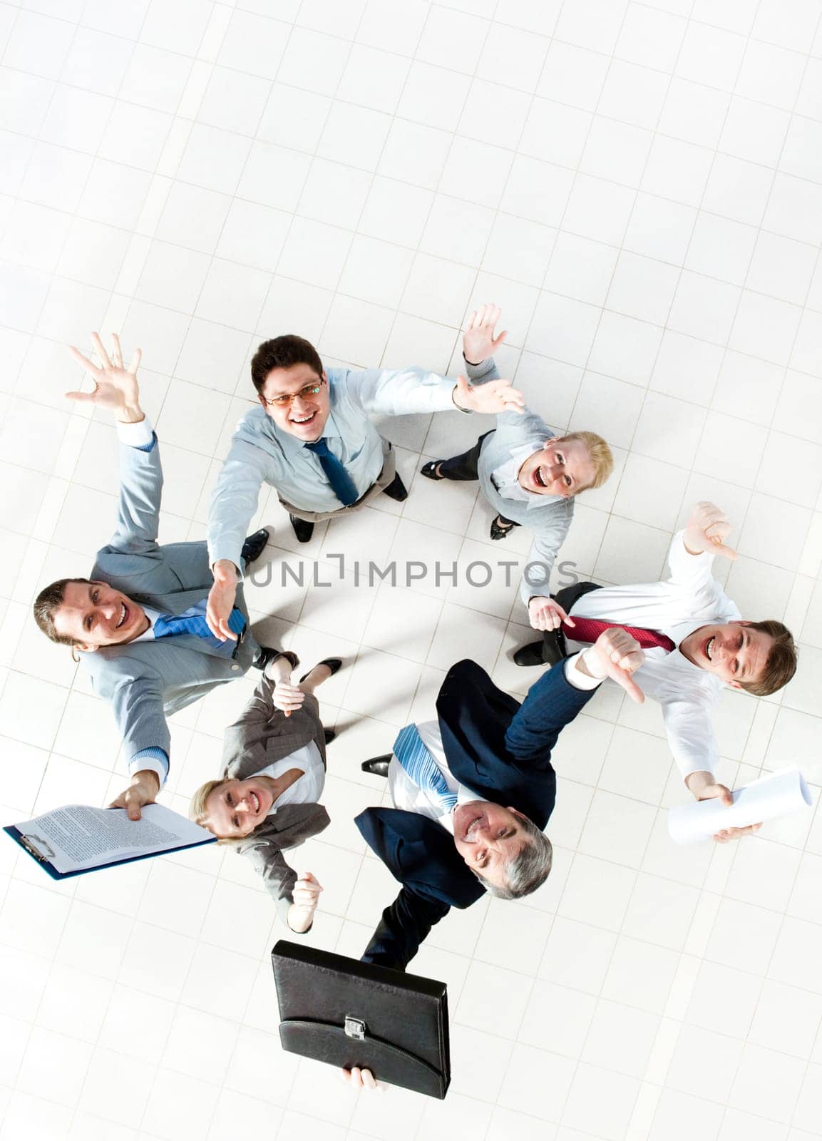 Above view of several successful partners laughing and looking at camera