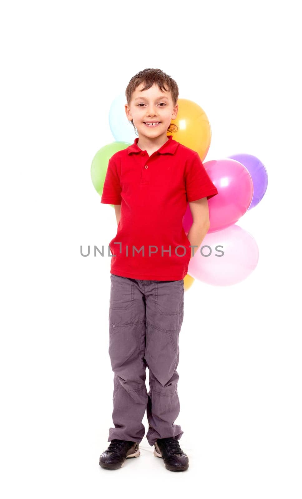 Portrait of happy boy with colorful balloons at birthday party