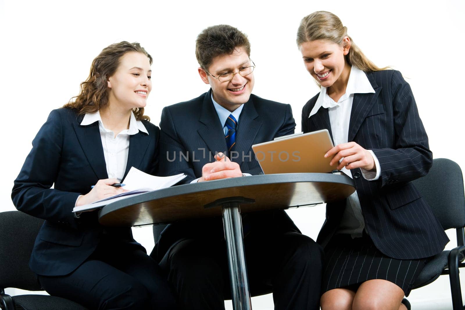 Group of three business people sitting at the table and working