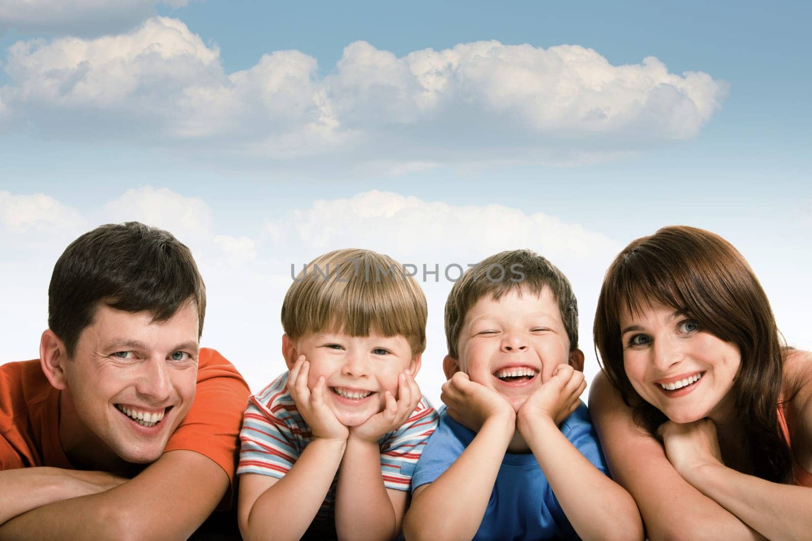 Line of happy family members looking at camera and smiling over white background