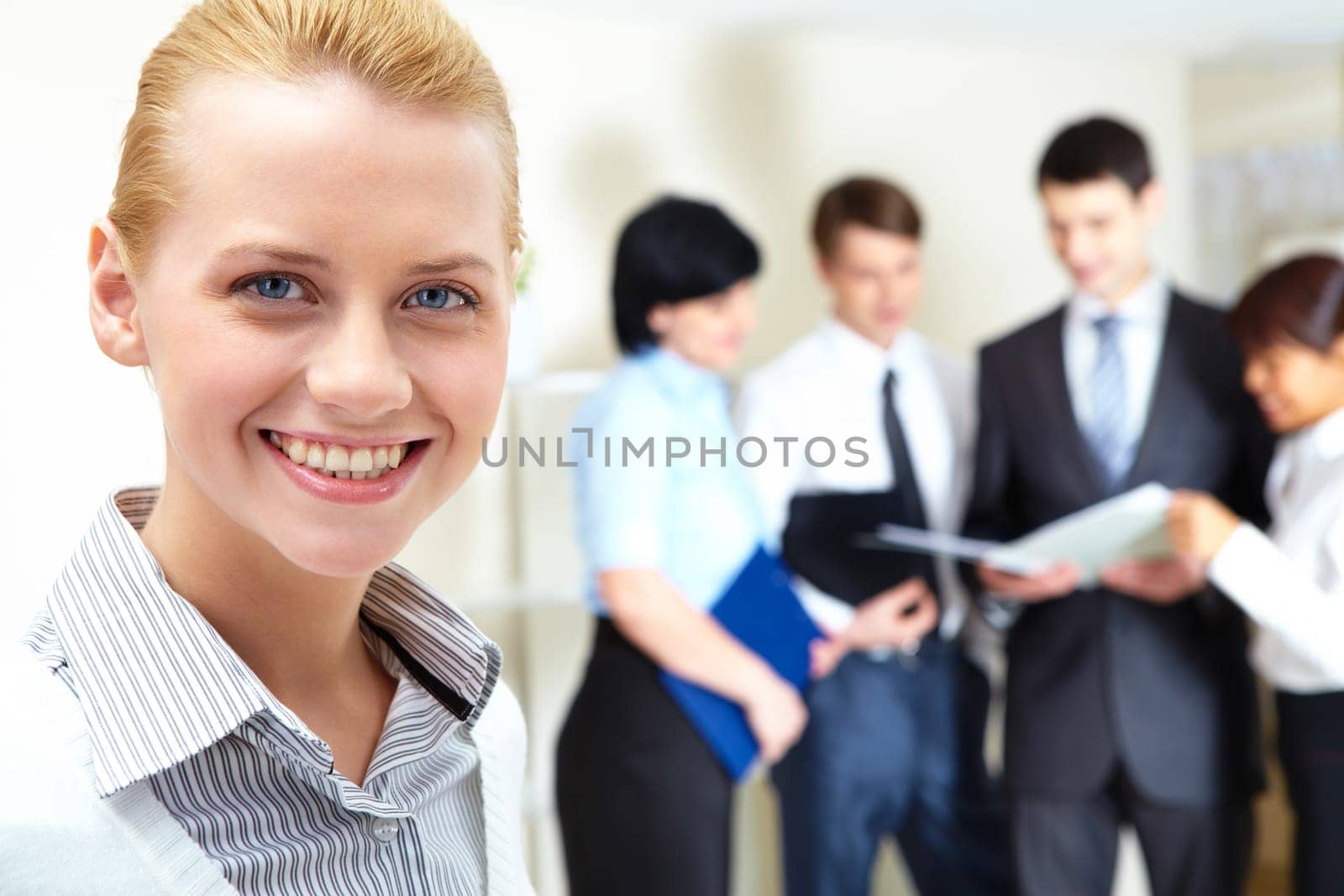 Image of pretty female looking at camera in working environment