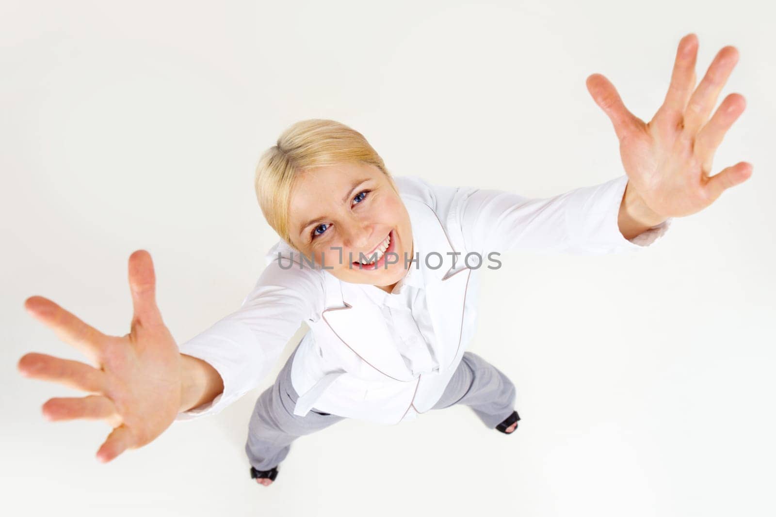 Above view of successful businesswoman stretching her arms at camera