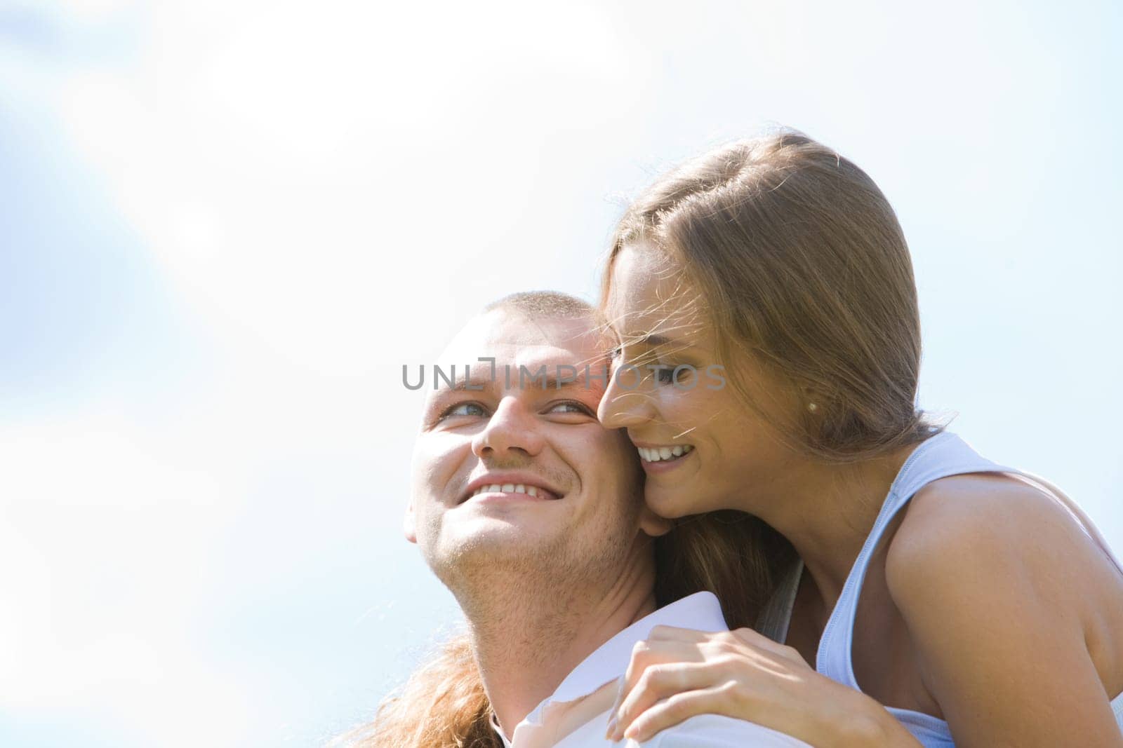 Photo of happy girl and handsome guy having fun against blue sky