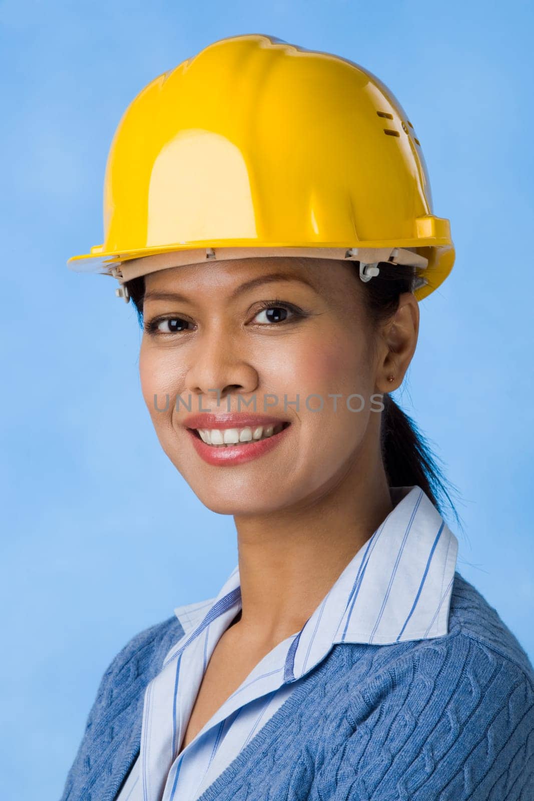 Portrait of pretty female with helmet on head looking at camera
