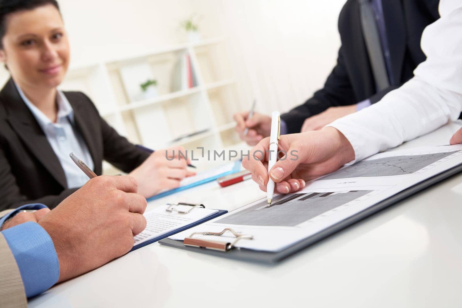 Close-up of business person hand over document in working environment