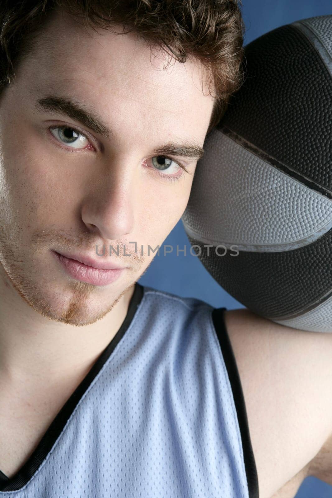 Basket player young man over blue grunge background