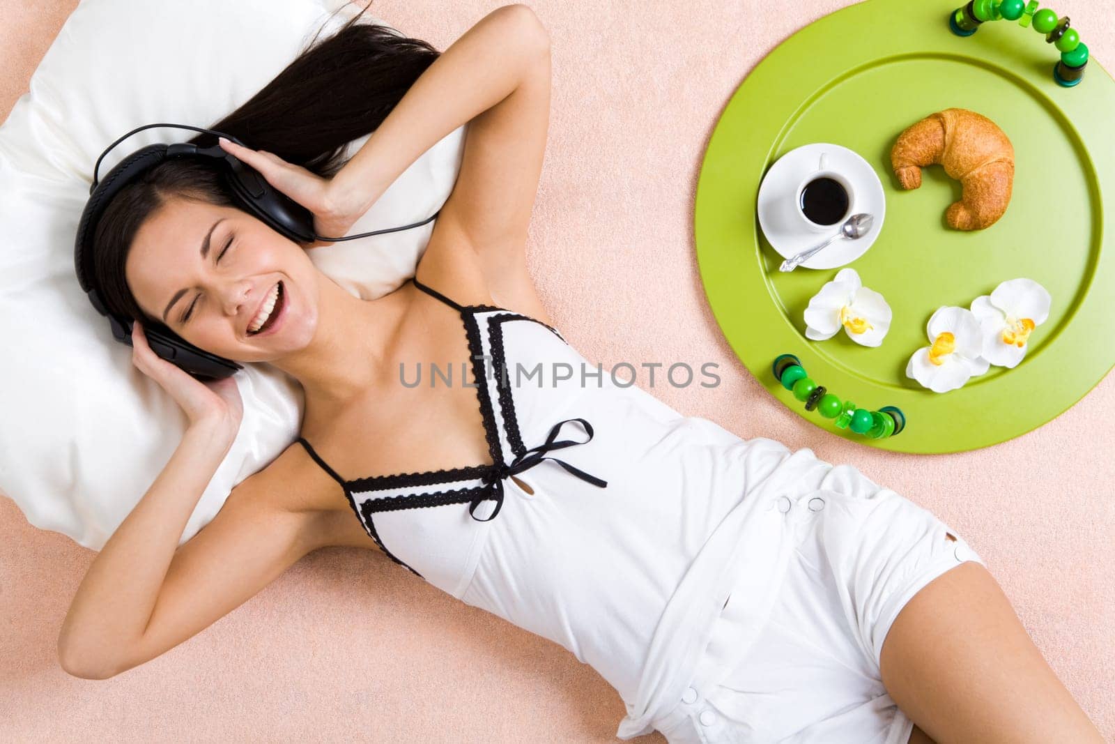 Pretty girl listening to music in headphones and taking pleasure in it