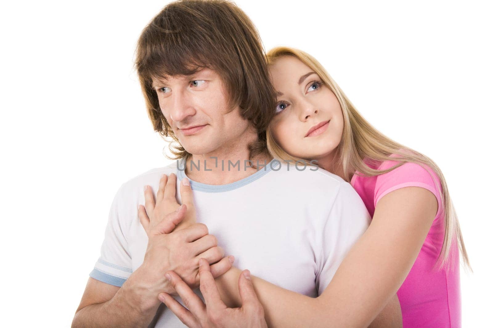 Portrait of attractive young girl embracing her boyfriend over white background