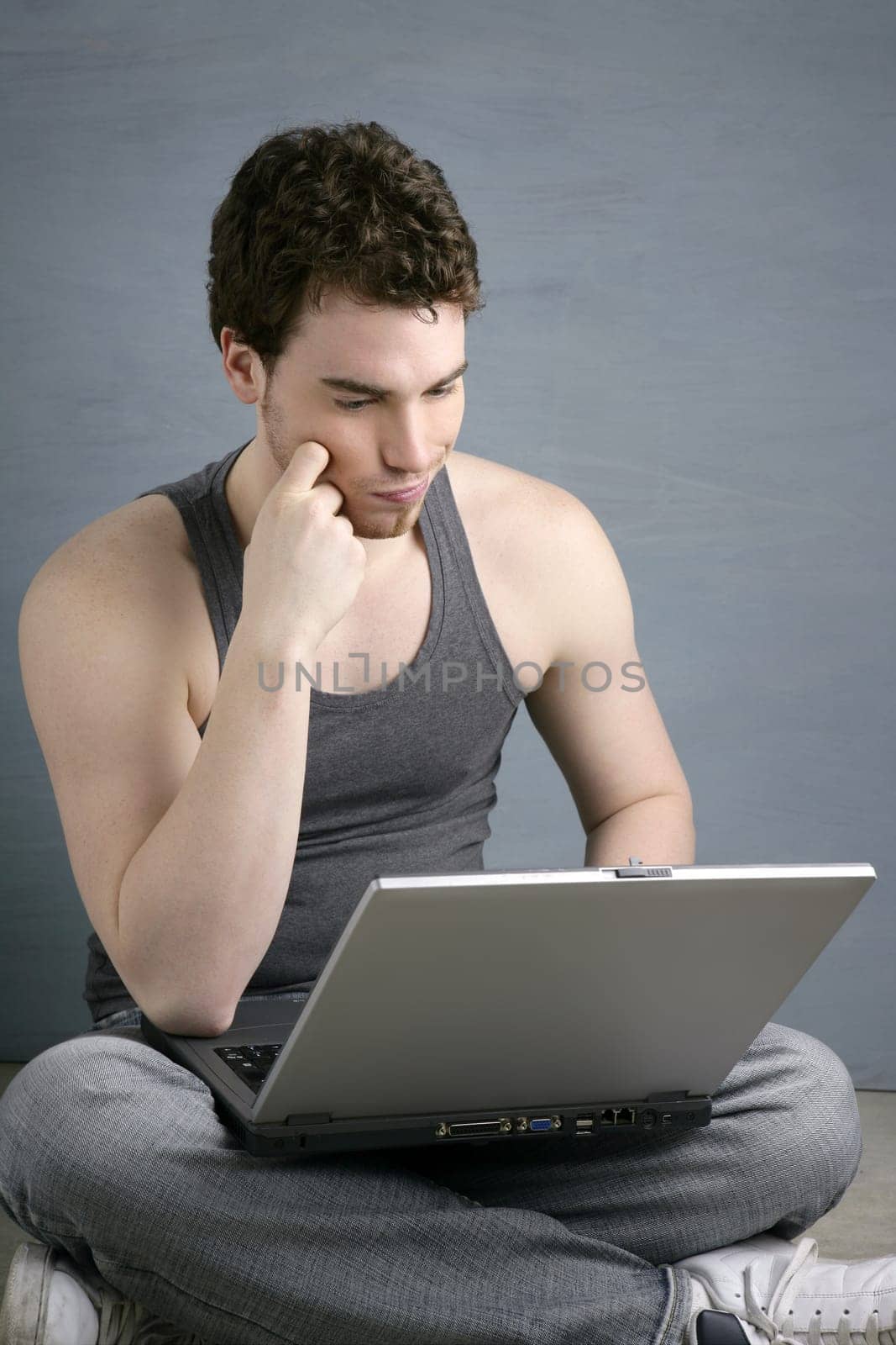 student gesture with laptop over gray background