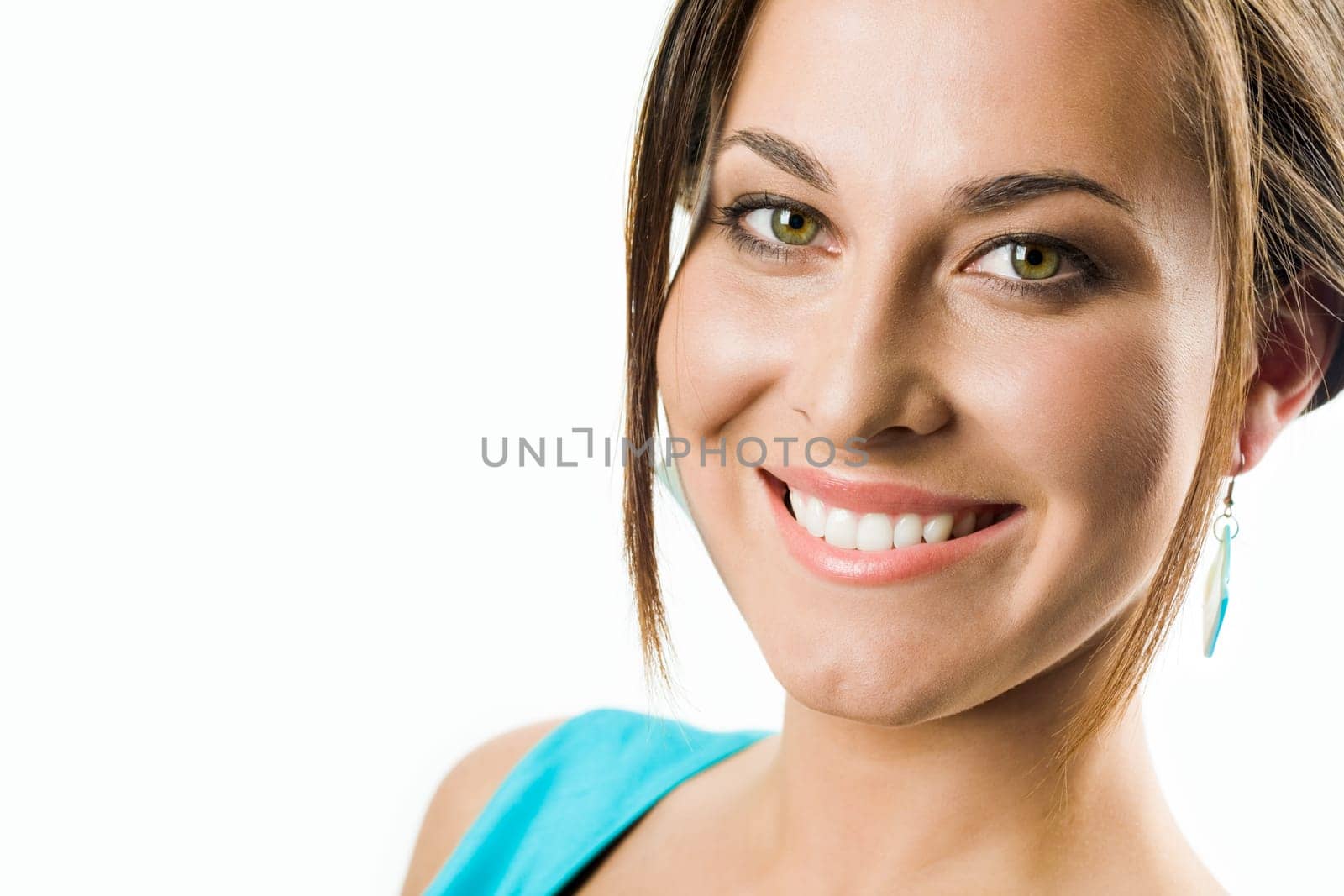 Face of pretty girl looking at camera with smile over white background