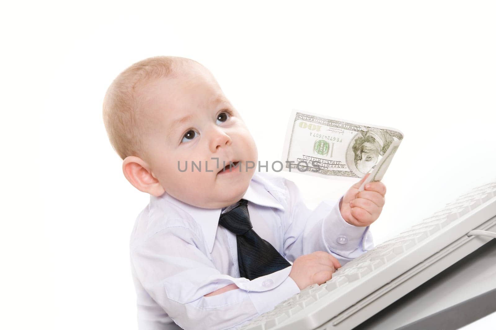 Portrait of serious baby boy giving hundred-dollar banknote to someone