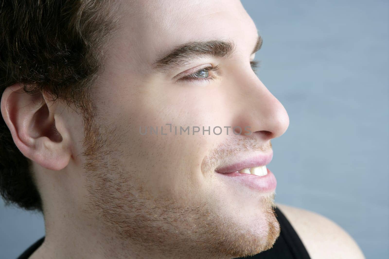 handsome profile smile portrait young man face detail closeup