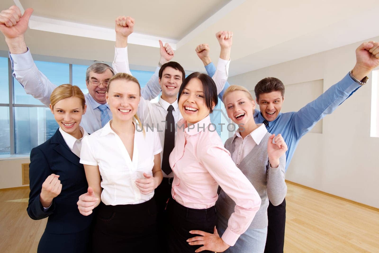 Portrait of successful people raising hands showing gladness