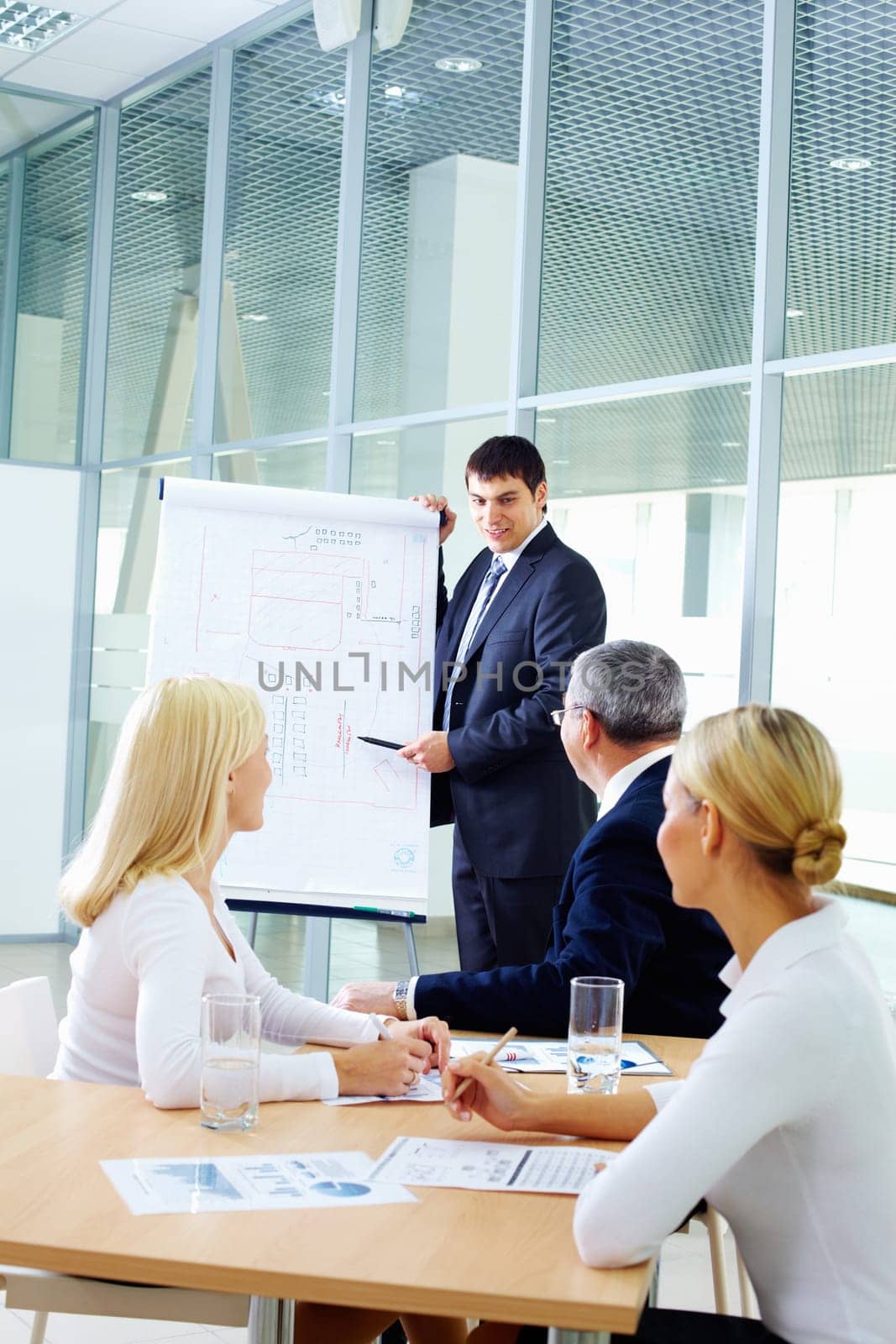 Businessman showing a plan to his colleagues
